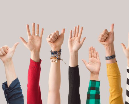 several hands raised in the air
